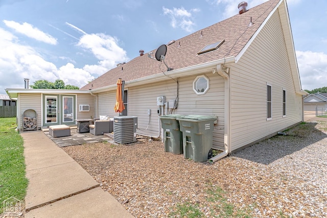 13326 Dixie Ln, Trumann, AR 72472 - rear view of house with outdoor lounge area, a patio, and a shingled roof