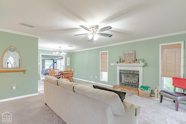 13326 Dixie Ln, Trumann, AR 72472 - living room with ornamental molding, carpet flooring, ceiling fan, a fireplace, and a chandelier
