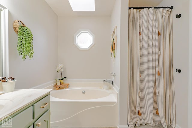 13326 Dixie Ln, Trumann, AR 72472 - full bath featuring a skylight, a garden tub, vanity, and a shower with curtain