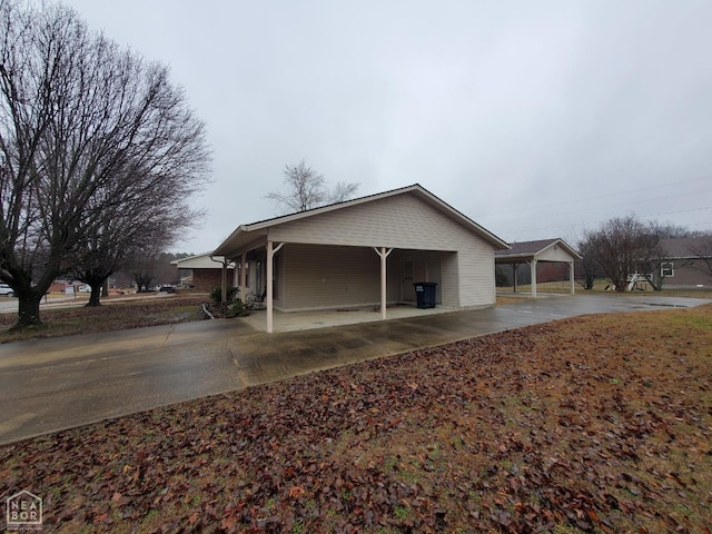 view of side of home with a carport and driveway