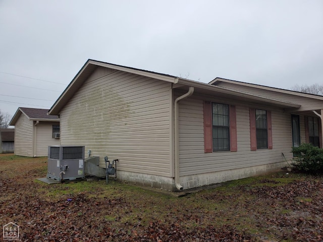 view of side of home with central AC unit