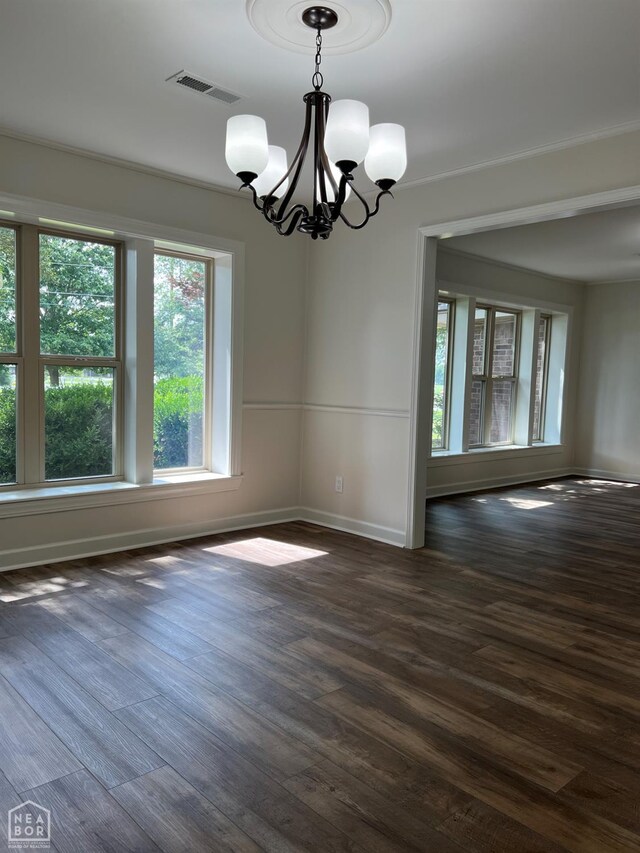 318 Davis St, Manila, AR 72442 - empty room with a chandelier and dark wood-style flooring