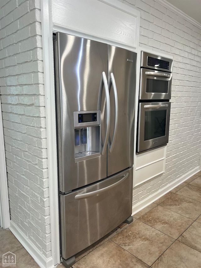 318 Davis St, Manila, AR 72442 - detailed view of stainless steel appliances, brick wall, and ornamental molding