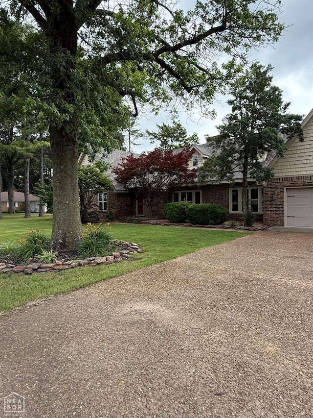 318 Davis St, Manila, AR 72442 - view of front of house with a front yard and concrete driveway