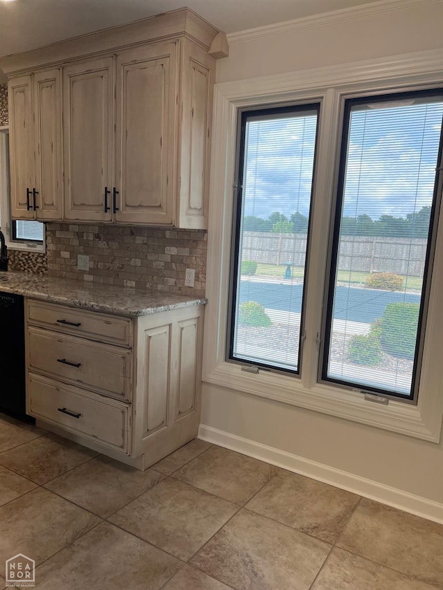 318 Davis St, Manila, AR 72442 - kitchen featuring black dishwasher, tasteful backsplash, plenty of natural light, crown molding, and light tile patterned flooring