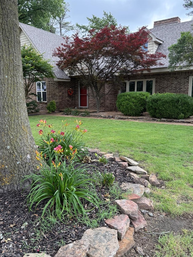 318 Davis St, Manila, AR 72442 - view of front of property with roof with shingles, a front lawn, and brick siding