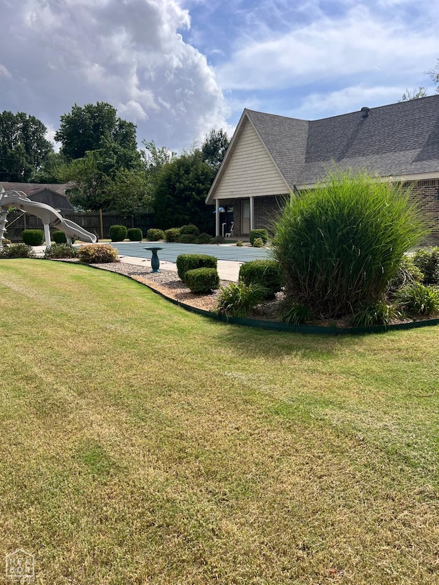 318 Davis St, Manila, AR 72442 - view of grassy yard with an outdoor pool