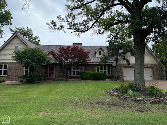 318 Davis St, Manila, AR 72442 - view of front of house featuring brick siding, driveway, a front lawn, and an attached garage