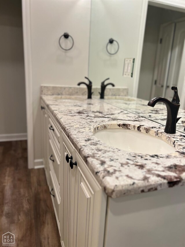318 Davis St, Manila, AR 72442 - bathroom with double vanity and wood finished floors