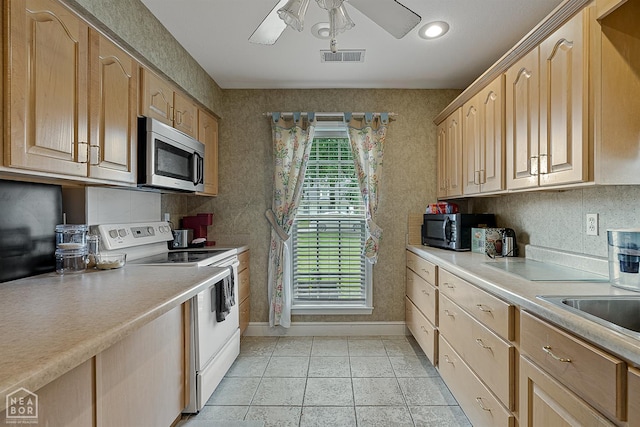 328 Natchez Dr, Jonesboro, AR 72404 - kitchen with stainless steel microwave, white electric range, black microwave, healthy amount of natural light, and recessed lighting