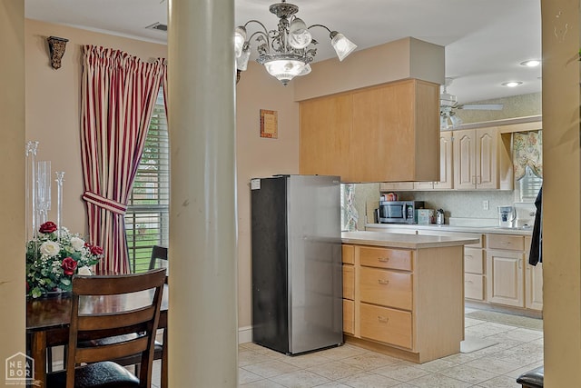 328 Natchez Dr, Jonesboro, AR 72404 - kitchen featuring appliances with stainless steel finishes, light brown cabinets, light countertops, and light tile patterned floors
