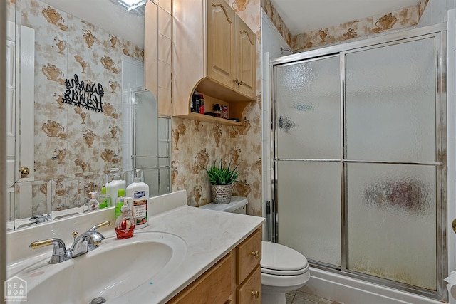 328 Natchez Dr, Jonesboro, AR 72404 - bathroom featuring vanity, a shower stall, wallpapered walls, and tile patterned flooring