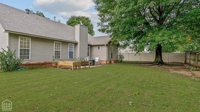 328 Natchez Dr, Jonesboro, AR 72404 - back of house with a fenced backyard, a chimney, roof with shingles, and a patio