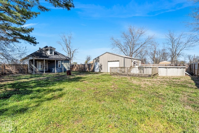 605 SE 2nd St SE, Hoxie, AR 72433 - view of yard featuring an outbuilding, a fenced backyard, a fenced in pool, and a garage