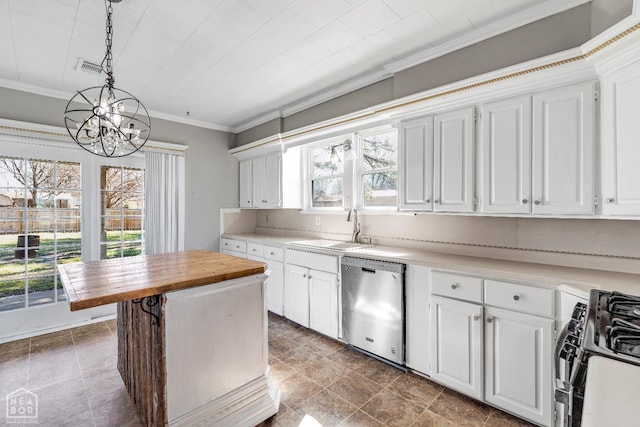 605 SE 2nd St SE, Hoxie, AR 72433 - kitchen with dishwasher, a sink, a chandelier, butcher block counters, and gas range oven