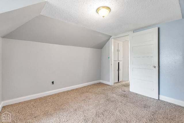 605 SE 2nd St SE, Hoxie, AR 72433 - bonus room featuring a textured ceiling, baseboards, light carpet, and lofted ceiling