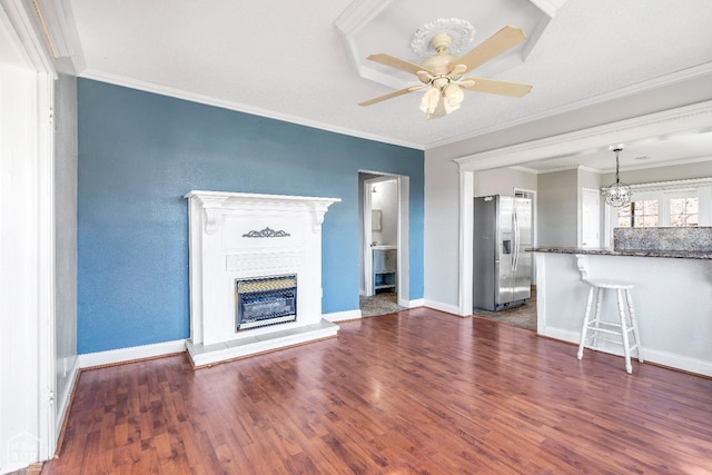 605 SE 2nd St SE, Hoxie, AR 72433 - unfurnished living room featuring wood finished floors, ceiling fan with notable chandelier, and ornamental molding