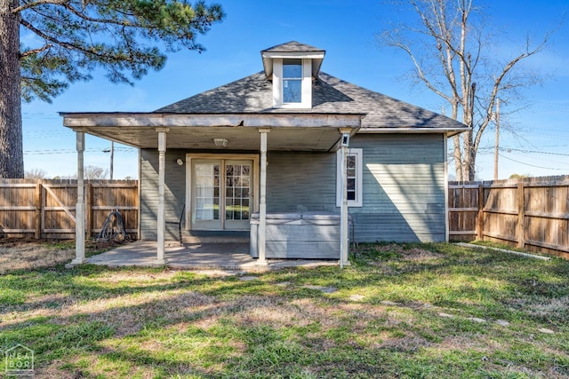 605 SE 2nd St SE, Hoxie, AR 72433 - back of house featuring french doors, a yard, a fenced backyard, and a patio area