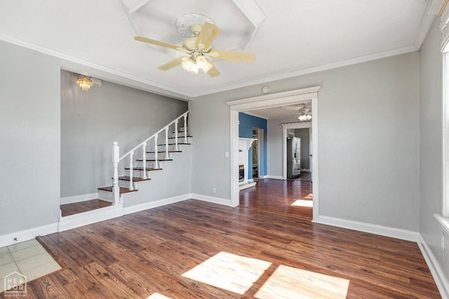 605 SE 2nd St SE, Hoxie, AR 72433 - empty room featuring stairs, wood finished floors, ornamental molding, and ceiling fan