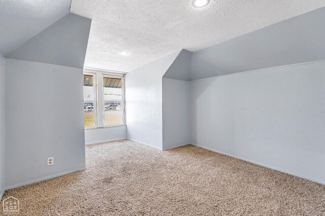 605 SE 2nd St SE, Hoxie, AR 72433 - additional living space featuring carpet, a textured ceiling, baseboards, and lofted ceiling
