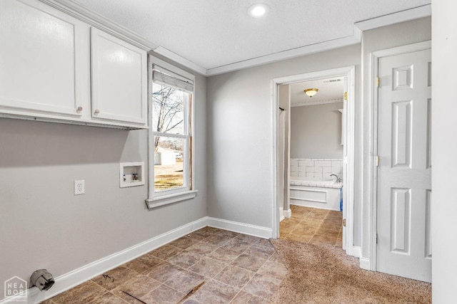605 SE 2nd St SE, Hoxie, AR 72433 - clothes washing area featuring baseboards, ornamental molding, a textured ceiling, washer hookup, and cabinet space