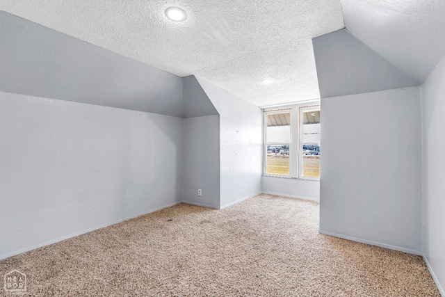 605 SE 2nd St SE, Hoxie, AR 72433 - additional living space with carpet flooring, a textured ceiling, and vaulted ceiling