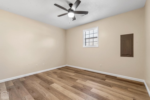 202 S 14th Ave, Paragould, AR 72450 - spare room with electric panel, baseboards, wood finished floors, and a ceiling fan