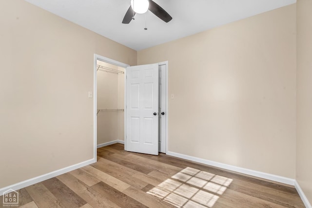 202 S 14th Ave, Paragould, AR 72450 - spare room with wood finished floors, ceiling fan, and baseboards