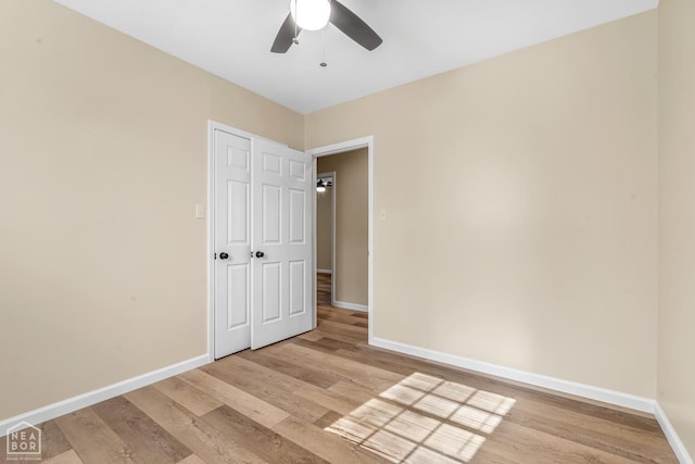 202 S 14th Ave, Paragould, AR 72450 - unfurnished bedroom with light wood finished floors, baseboards, and a ceiling fan