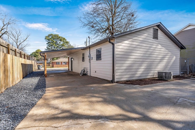 202 S 14th Ave, Paragould, AR 72450 - view of side of property featuring concrete driveway, a carport, and central AC