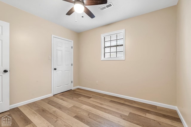 202 S 14th Ave, Paragould, AR 72450 - unfurnished bedroom with light wood-style floors, baseboards, and a ceiling fan