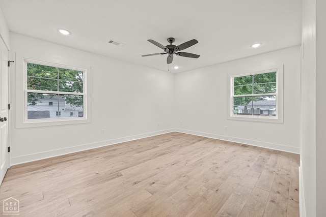 spare room featuring baseboards, recessed lighting, visible vents, ceiling fan, and light wood finished floors