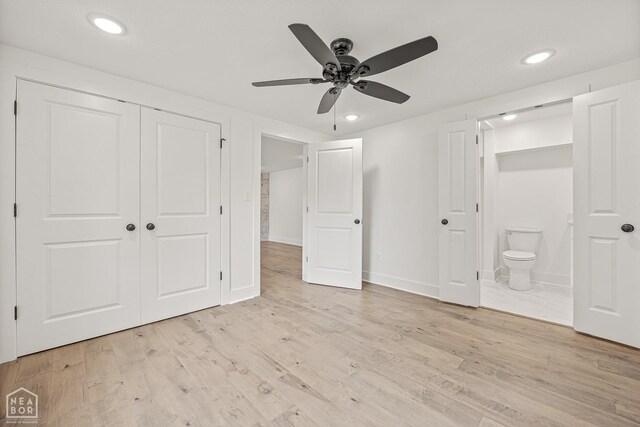 unfurnished bedroom with wood finished floors, ensuite bath, a closet, and recessed lighting
