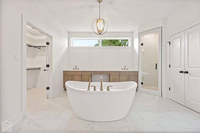 full bath featuring a sink, baseboards, a shower stall, and marble finish floor