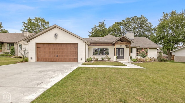 view of front of property with driveway, an attached garage, a front lawn, and a chimney