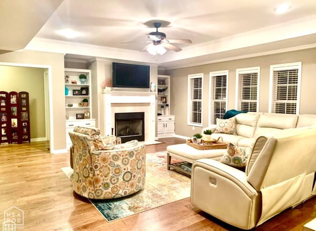 4105 Renee Dr, Jonesboro, AR 72404 - living room featuring ceiling fan, ornamental molding, a fireplace with flush hearth, baseboards, and built in shelves