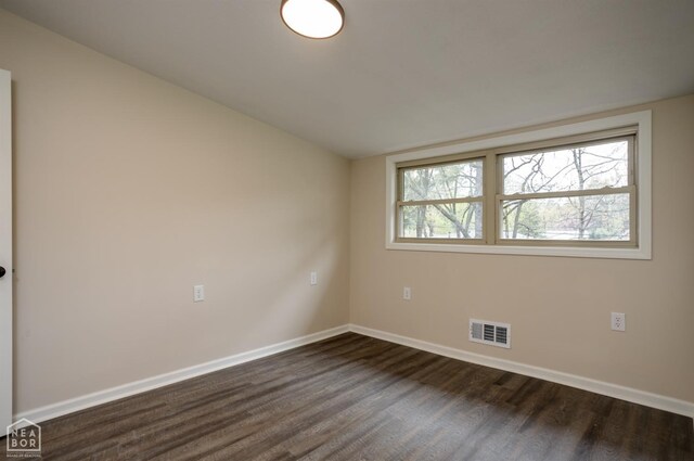 unfurnished room with visible vents, baseboards, and a wealth of natural light