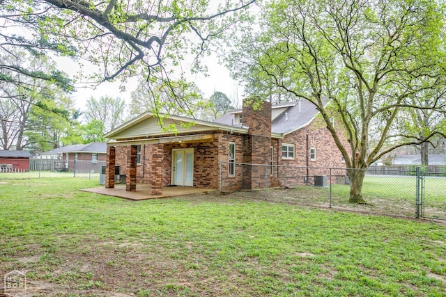 rear view of house featuring a yard, a patio, a fenced backyard, and central air condition unit