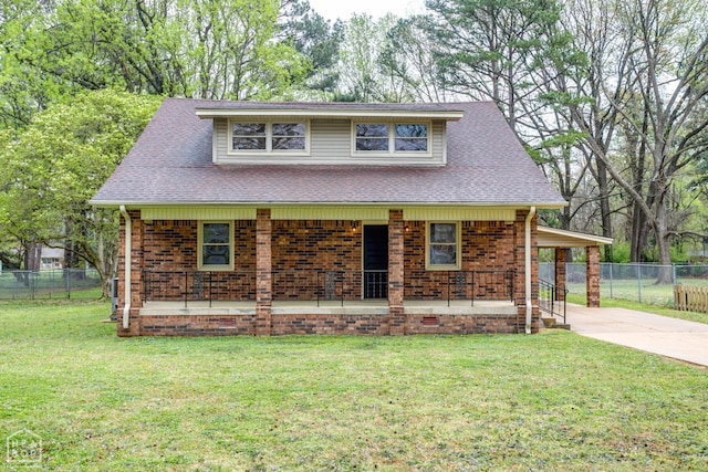 view of front of home with roof with shingles, driveway, fence, and a front lawn