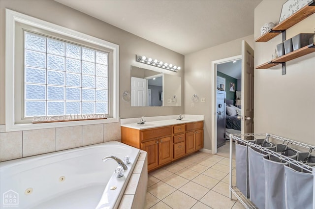 2105 Quarry Cv, Jonesboro, AR 72404 - full bath with a jetted tub, tile patterned flooring, ensuite bathroom, double vanity, and baseboards