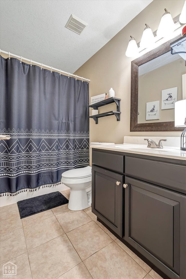 5507 Cordova Ln, Jonesboro, AR 72404 - full bathroom featuring toilet, tile patterned flooring, vanity, a textured ceiling, and curtained shower
