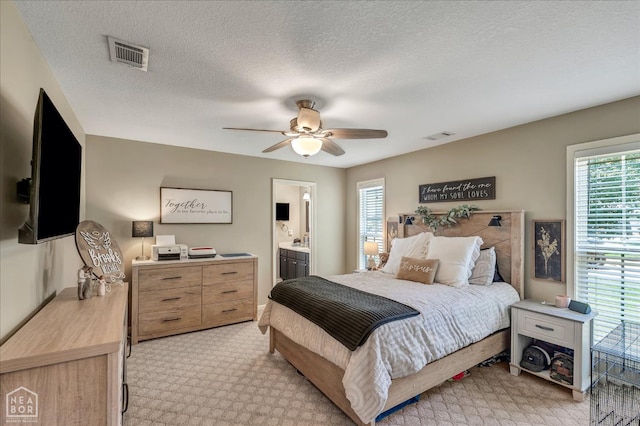 5507 Cordova Ln, Jonesboro, AR 72404 - bedroom with multiple windows, light colored carpet, a ceiling fan, ensuite bath, and a textured ceiling