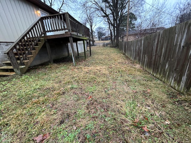 view of yard with stairs, a fenced backyard, and a wooden deck