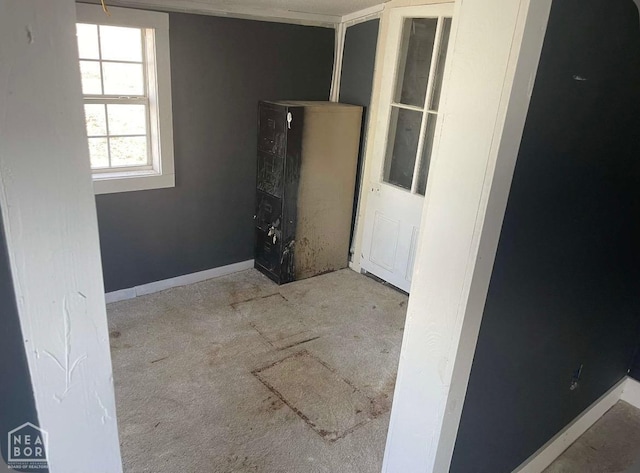empty room with baseboards and carpet floors