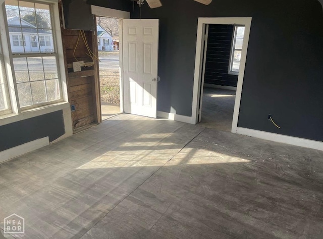 empty room with baseboards and ceiling fan