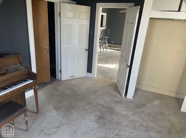 interior space with baseboards and carpet