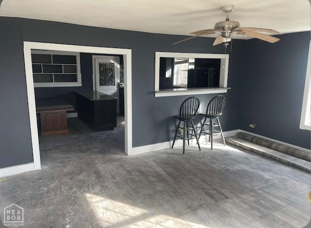 interior space with a ceiling fan and outdoor dry bar