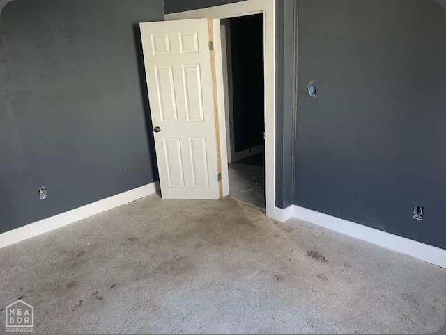 interior space featuring carpet flooring and baseboards