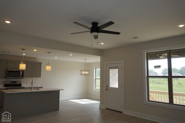 1814 N Oak, Brookland, AR 72417 - spare room with recessed lighting, baseboards, wood finished floors, and ceiling fan with notable chandelier