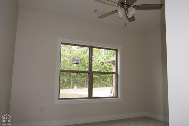 spare room featuring visible vents, a ceiling fan, baseboards, and light colored carpet
